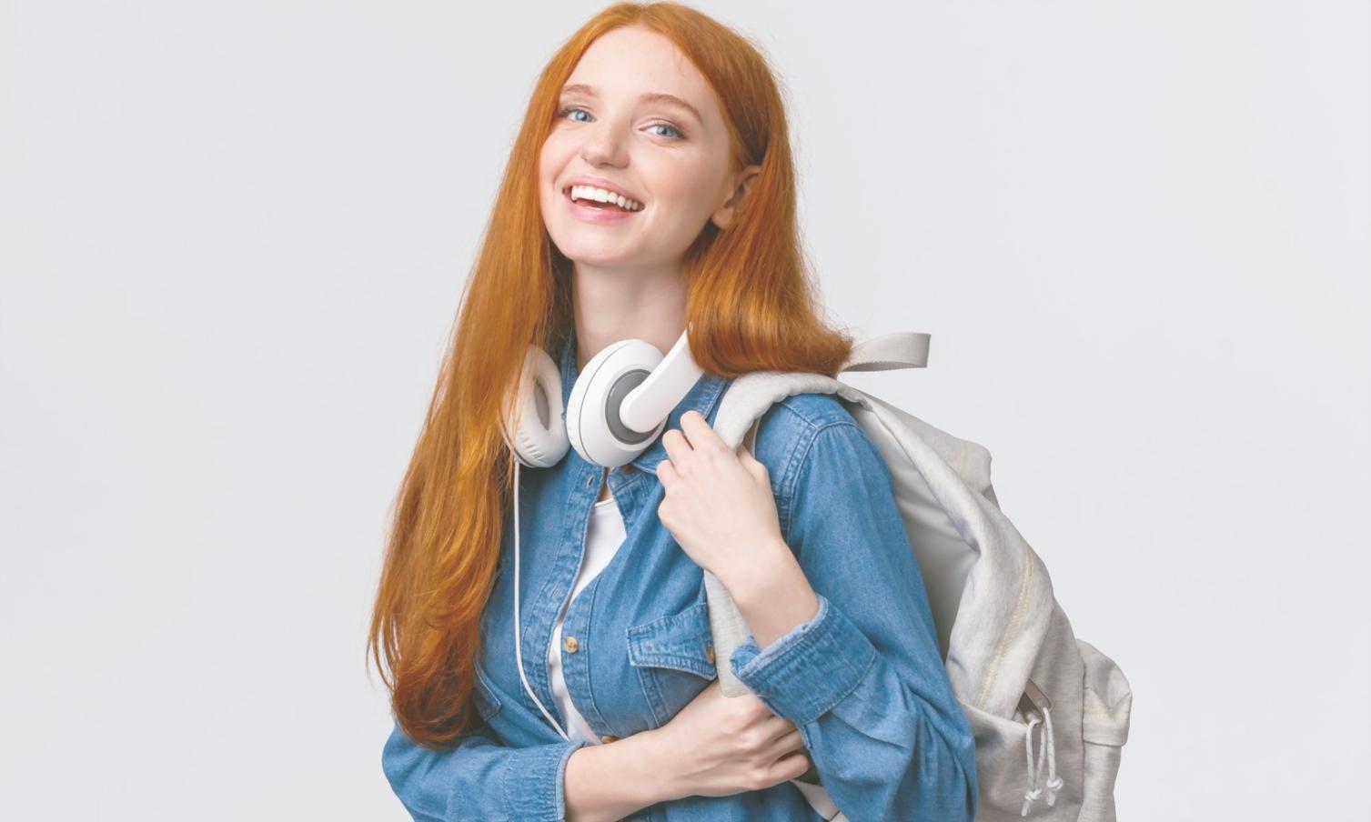 Student analyzing financial data on multiple screens during scenario modeling workshop